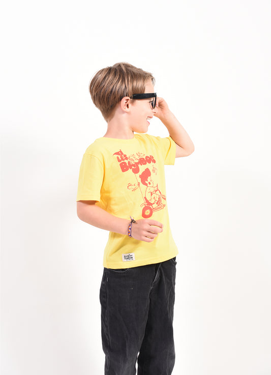 Child wearing a yellow t-shirt with a graphic design on a white background