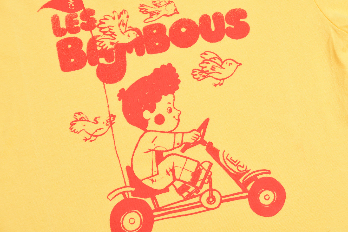 Illustration of a child on a toy car with 'Les Bimbous' text on a yellow background
