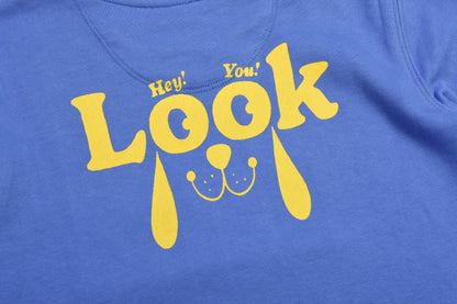 Blue t-shirt with yellow text 'Hey! You! Look!' on a blue background