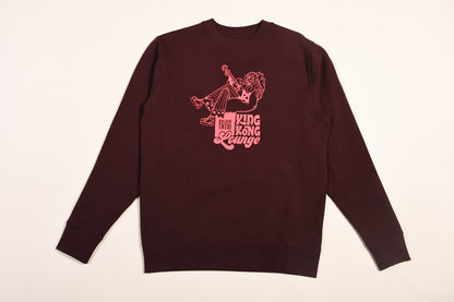  a long-sleeved burgundy red sweater with a graphic print of King Kong on a white background
