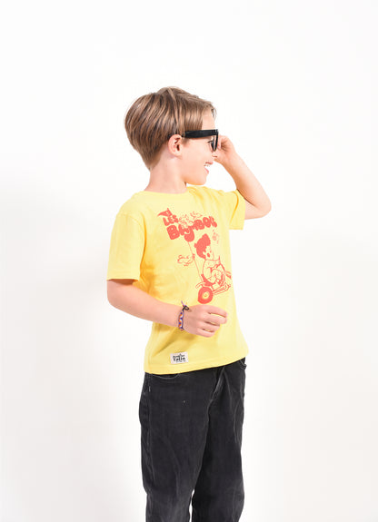 Child wearing a yellow t-shirt with a graphic design on a white background