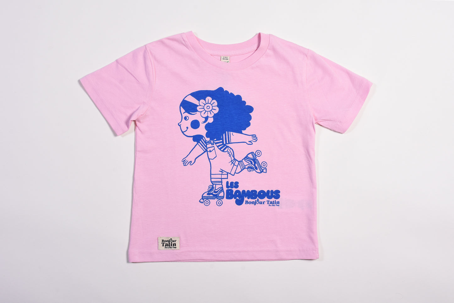 Pink t-shirt with blue graphic design on a light gray background