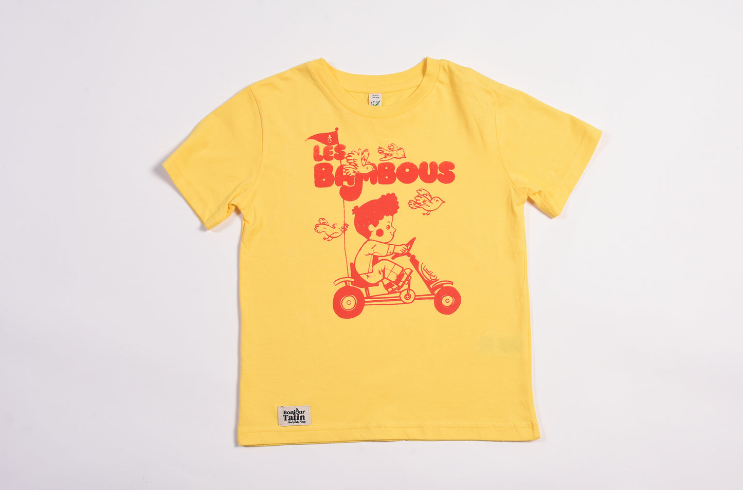Yellow t-shirt with a cartoon character and text on a light gray background