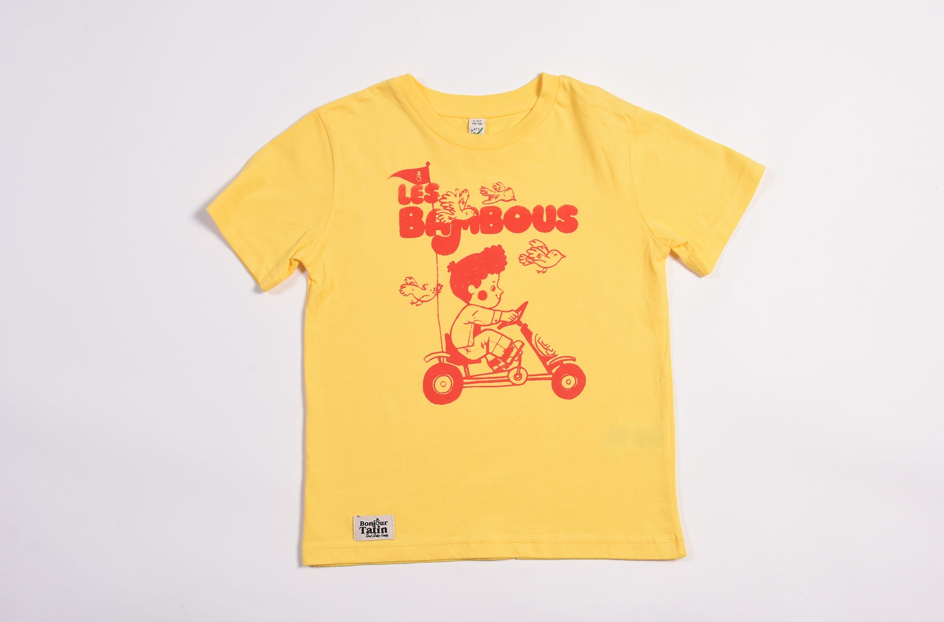 Yellow t-shirt with a cartoon character and text on a light gray background