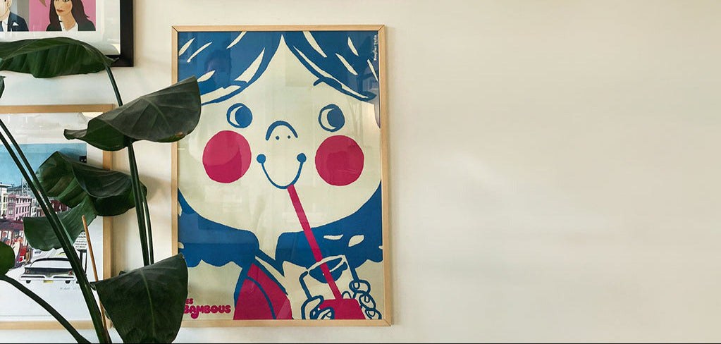 Colorful cartoon-style girl drinking lemonade poster on a wall with blue and red 